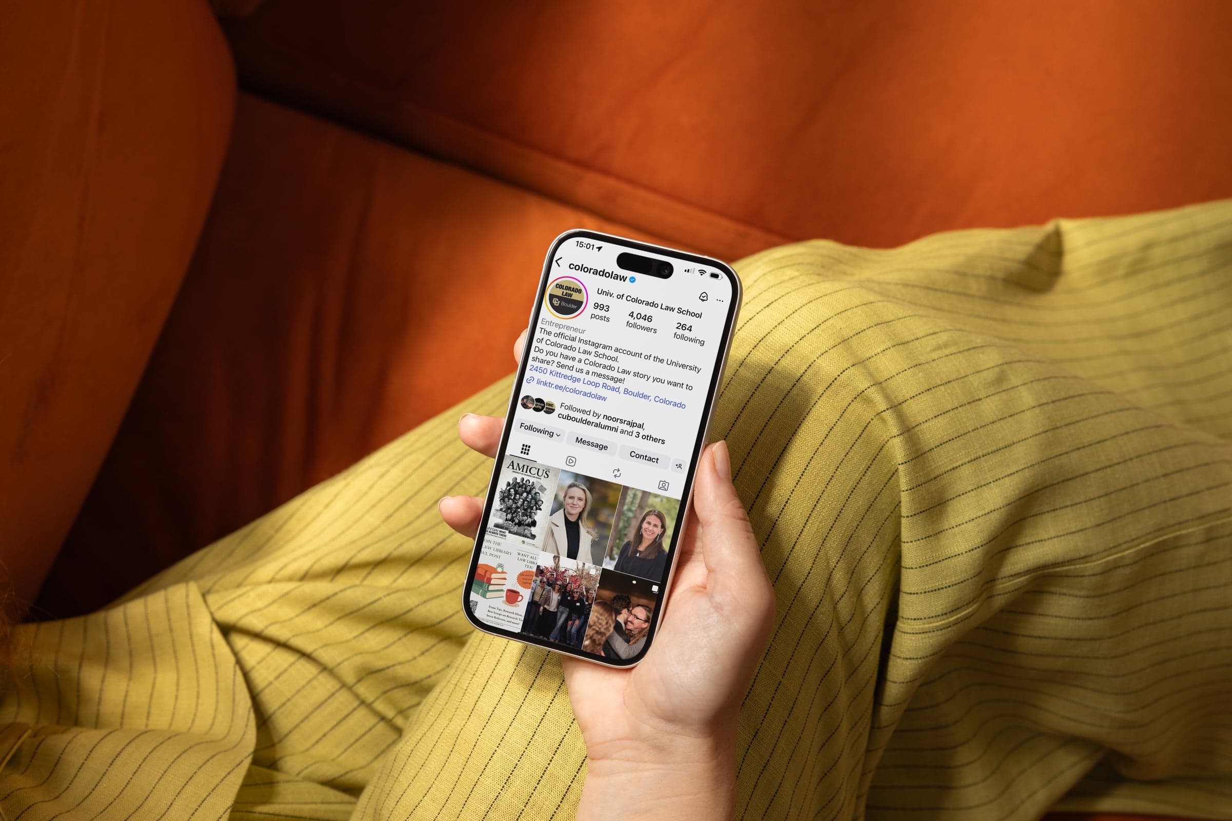 Hand holding a phone showing the University of Colorado Law School Instagram profile